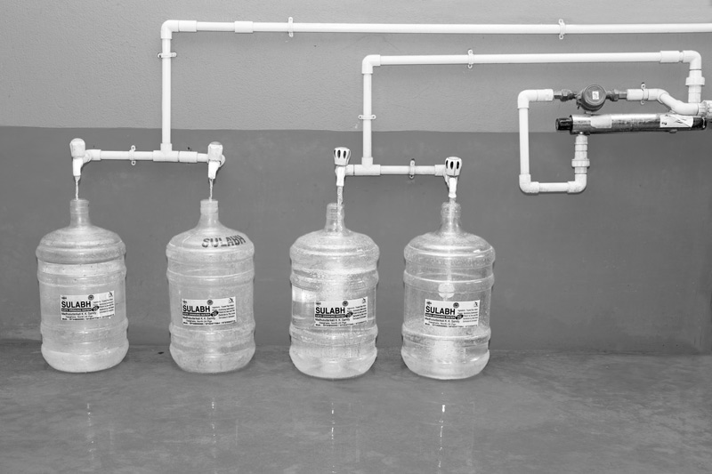 The treated pure drinking water emerging from the UV filter being filled in 20 litres plastic jars under Sulabh Safe Drinking Water project in arsenic-affected village Madhusudankati, North 24 parganas district, West Bengal